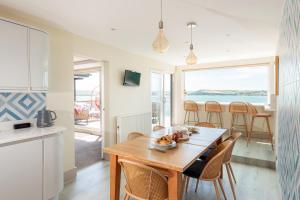 a kitchen and dining room with a table and chairs at 3 Bed Stylish Beachfront Retreat in Roche