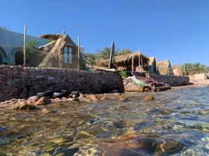 a group of houses on the shore of the water at kalima camp in Nuweiba‘ el Muzeinah