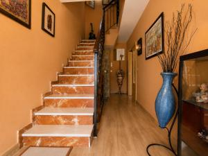a staircase in a home with a blue vase at La Aracelitana in Lucena