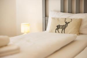 a bed with a pillow with a deer on it at Ferienwohnung Panoramablick - super für deine Familie und die besten Aussicht in ganz Todtmoos in Todtmoos