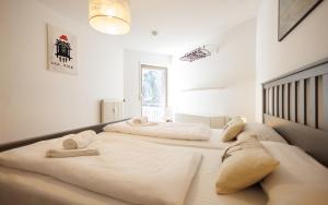 two beds in a room with white walls at Ferienwohnung Panoramablick - super für deine Familie und die besten Aussicht in ganz Todtmoos in Todtmoos