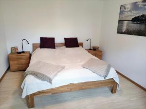 a bedroom with a large bed with two night stands at Ferienwohnungen Mamat in Haltern