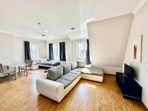 a living room with a couch and a table at Apartmenthouse Singen in Singen