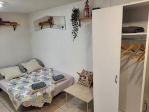 a bedroom with a bed and a chair at Apartma Oliva in Koper
