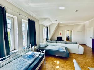 a large room with two beds and a couch at Apartmenthouse Singen in Singen