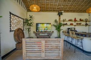 a living room with a tv and a table and chairs at Sacred Padi Ubud Villa in Payangan