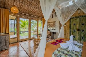 a bedroom with a bed with a canopy at Sacred Padi Ubud Villa in Payangan +151 photos