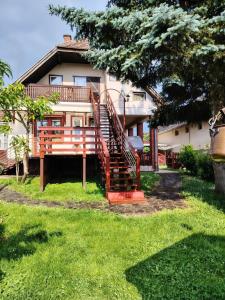 a house with a staircase in front of it at Őrségi Lápréti Vendégház in Szőce