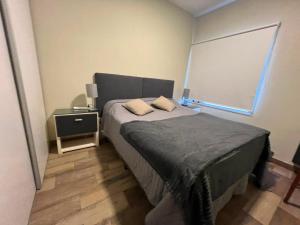 a small bedroom with a bed and a window at Coty B in Saladillo
