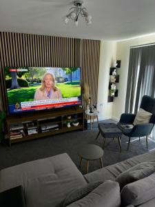 a living room with a flat screen tv at Blackrod Homestay in Blackrod +2 photos