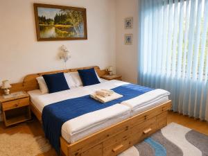 a bedroom with a bed with two towels on it at Penzión Daria in Batizovce