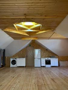 a large room with white appliances and a ceiling at Milikbek Dodikhudo in Khorog
