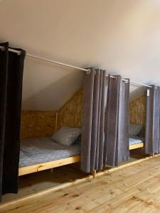 a room with two bunk beds with curtains at Milikbek Dodikhudo in Khorog