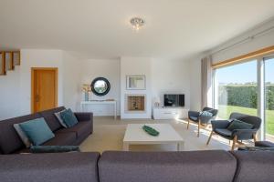 a living room with a couch and a table at Marvellous Villa in Óbidos