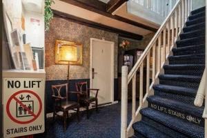 a staircase with a sign that says no lift stairs only at Hotel Prinsenhof Amsterdam in Amsterdam