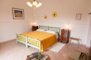 a bedroom with a bed and a table and a chair at Il Melo in Fivizzano
