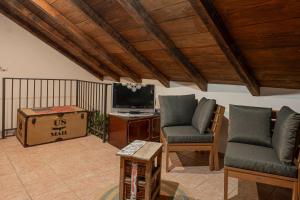 a living room with two chairs and a tv at Holiday House Rea with BBQ and two terrace in Sveti Donat
