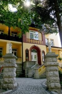 a large yellow building with a stone driveway at Villa Carmen in Kudowa-Zdrój +45 photos