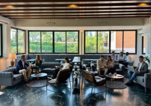 a group of people sitting in a waiting room at Pinewood Hotel Rome in Rome