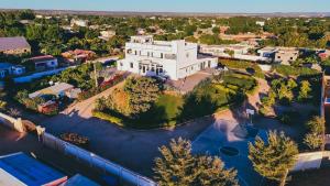an aerial view of a large white building next to a river at Belvédère Hôtel in Toliara