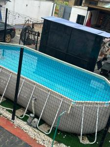 a tennis court with a net on top of it at whitestone palace hotel in Eggan