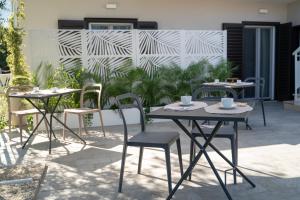 a patio with two tables and chairs with cups on them at Grania Le Radici - Agriresort in Gragnano
