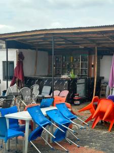 a group of chairs and tables in a patio at whitestone palace hotel in Eggan