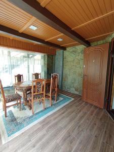 a dining room with a wooden table and chairs at Шепіт Лісу in Yaremche +12 photos