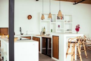 a kitchen with white counters and wooden cabinets at Kibuye House in Kibuye