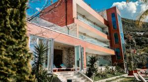 a house with glass doors on the side of it at Festim Villa Hotel in Kaninë +68 photos