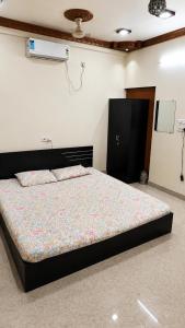 a bedroom with a large bed in a room at Maple studio in Patna