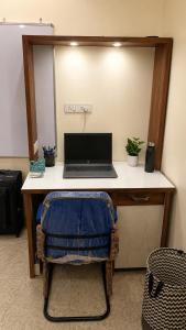 a desk with a laptop computer on top of it at Maple studio in Patna