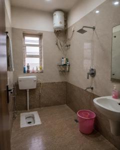a bathroom with a sink and a toilet in it at Maple studio in Patna