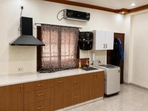 a kitchen with a sink and a stove top oven at Maple studio in Patna