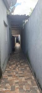 a hallway of a building with a stone walkway at kitnet, com tv,wifi in Sorocaba