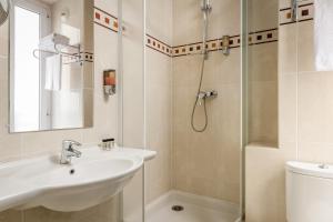 a bathroom with a sink and a shower at Hotel Elysée Etoile in Paris +22 photos