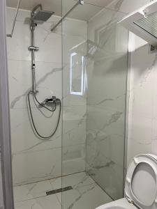 a bathroom with a glass shower with a toilet at Lake Breeze in Gjokaj +2 photos