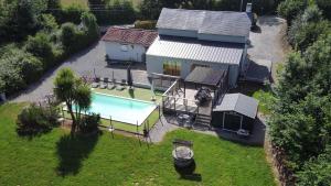 an aerial view of a house with a swimming pool at La maison Callinora in La Chapelle-Saint-Étienne