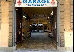a garage with cars parked inside of a building at VRooms All'Angolo Del Duomo in Florence