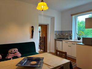 a living room with a couch and a table at Pod Lasem in Zwierzyniec