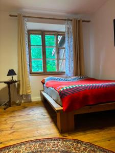a bedroom with a bed and a window at Pod Lasem in Zwierzyniec