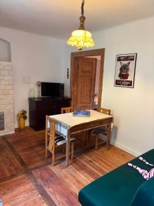 a dining room with a table and chairs and a light at Pod Lasem in Zwierzyniec