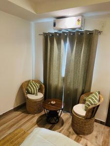 two chairs and a table in a room at Asoe living in Jorhat