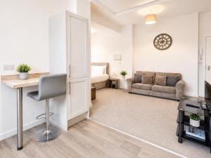 a living room with a desk and a couch at Modern new redeveloped studio Apartment in Clacton in Clacton-on-Sea