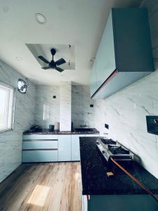 a kitchen with a ceiling fan and a counter top at Asoe living in Jorhat