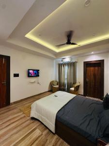 a bedroom with a bed and a tv on the ceiling at Asoe living in Jorhat