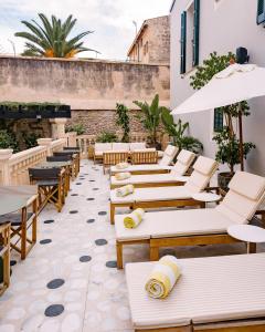 a row of tables and chairs on a patio at Concepcio by Nobis, Palma, a Member of Design Hotels in Palma de Mallorca