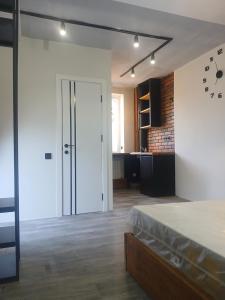 a large room with a bed and a kitchen at White House in Gyumri
