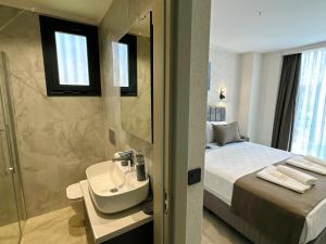 a bathroom with a bed and a sink and a shower at Prime Bodrum Villas in Bodrum City +7 photos