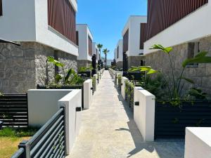 a walkway in front of a building with plants at Prime Bodrum Villas in Bodrum City
